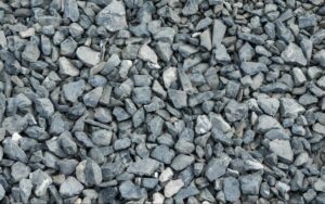A pile of small rocks varying in color from slate blue to light grey.