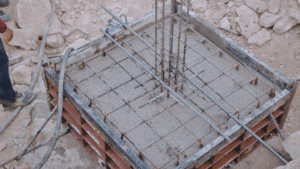Concrete poured over a rebar structure to create a foundation.